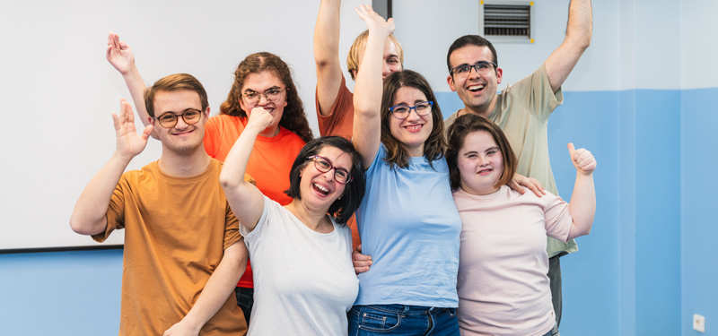 A group of people with disabilities cheering.