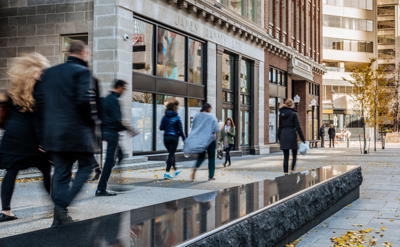 People walking in front of the Ramsey Building in downtown Edmonton