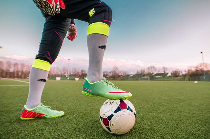 player with foot on soccer ball